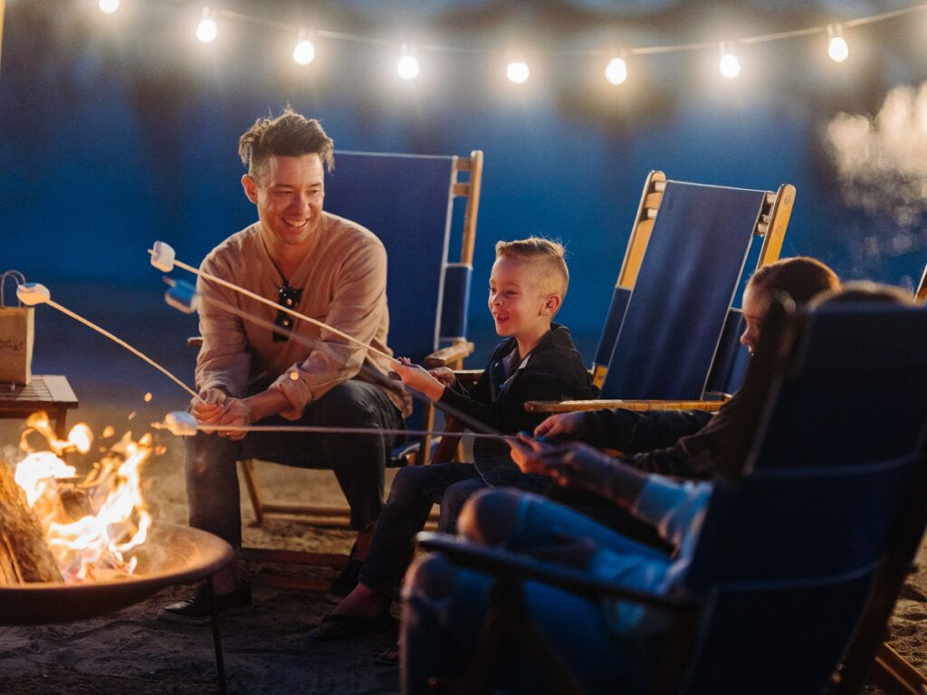 Family Making Smores On The Beach